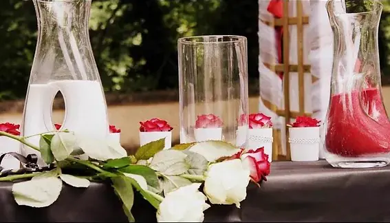 Roses rouges et blanches et carafes de sable, sur la table de la cérémonie